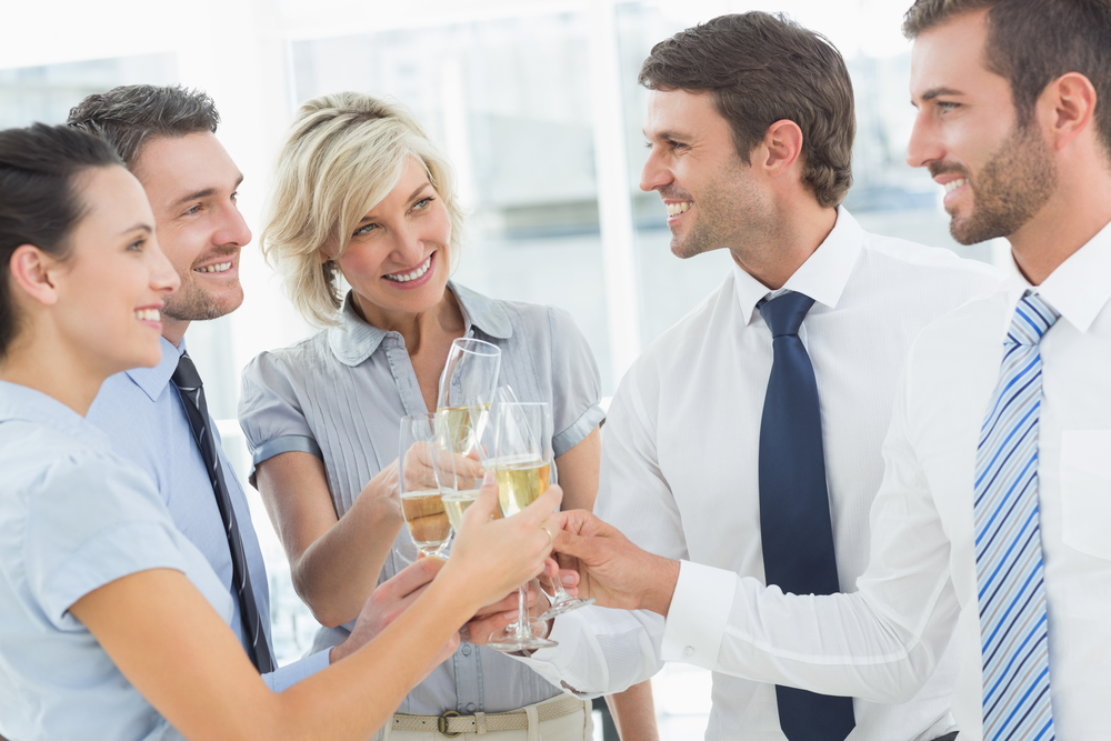 Group of happy business team toasting with champagne in the office