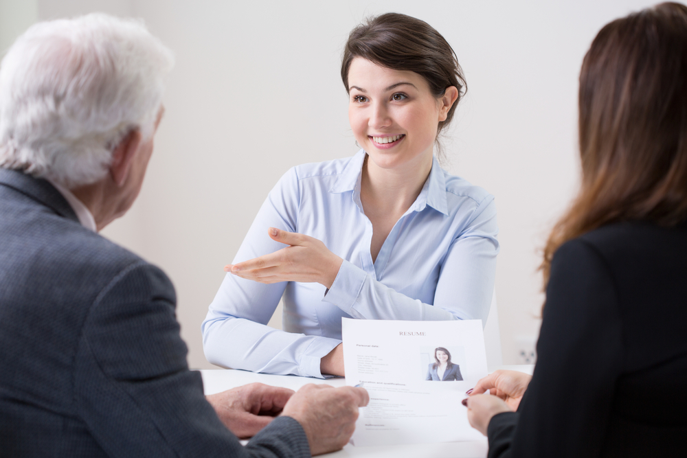 Human resources team during job interview with woman